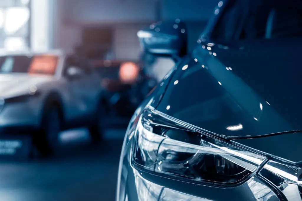 Selective focus grey car parked in luxury showroom