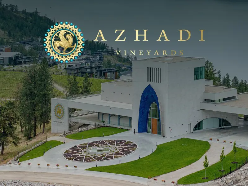 Azhadi Vineyards winery building above Okanagan Lake with the Azhadi logo