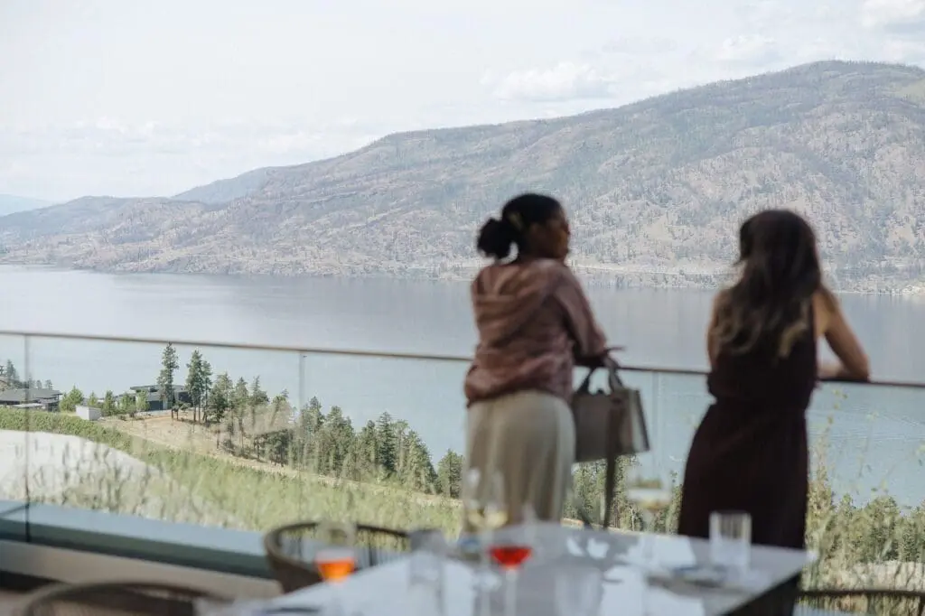 Guests on the Azhadi Vineyards terrace overlooking Okanagan Lake